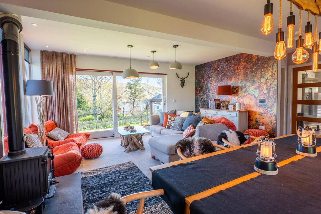a living room with a dog laying on a table at The Wolfie Lodge in Carbost