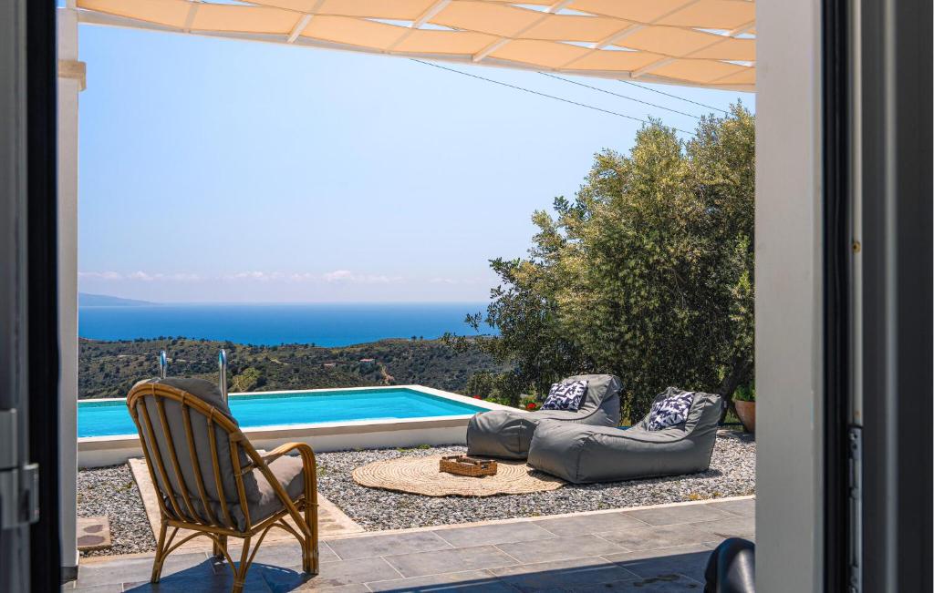 a patio with chairs and a view of the ocean at Prinos 3 in Agia Galini