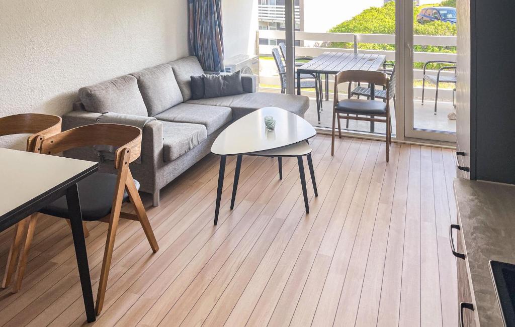 a living room with a couch and tables and chairs at Gorgeous Apartment In Ringkøbing With Wifi in Ringkøbing