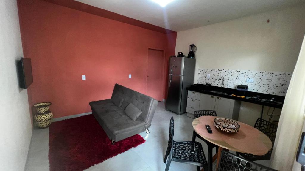 a kitchen with a table and a chair and a table and a small table at Apartamento no Centro da Cidade in Parauapebas
