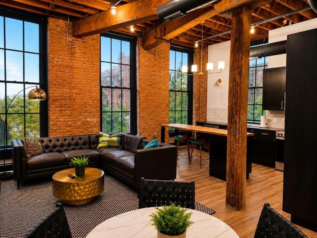 a living room with a couch and a table at Brick & Bed Riverfront Lofts, T 303 in Saint Louis