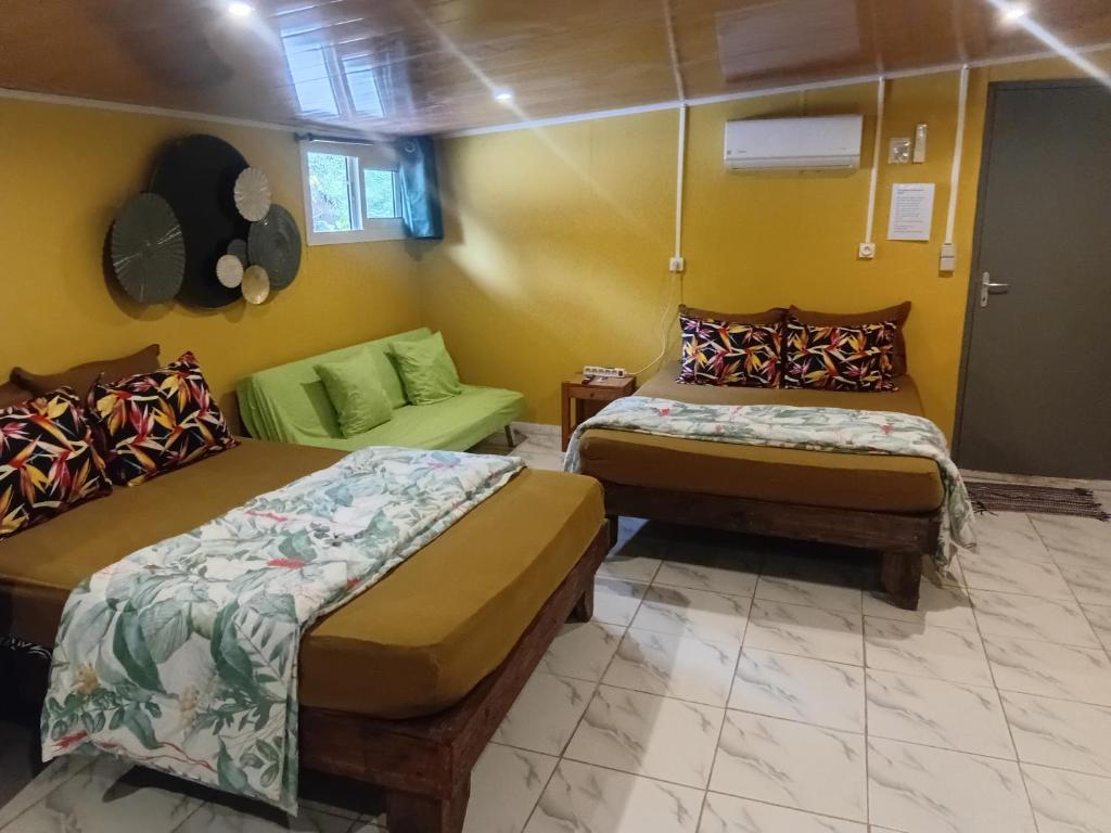 a room with two beds and a couch at Tereva home 1 in Bora Bora