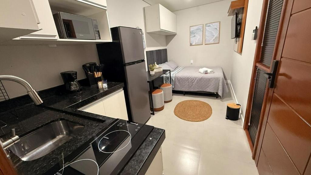 a kitchen with a sink and a bed in a room at LOFT 02 · Loft127-02 Compacto, equipado, ótima localização in Itajaí