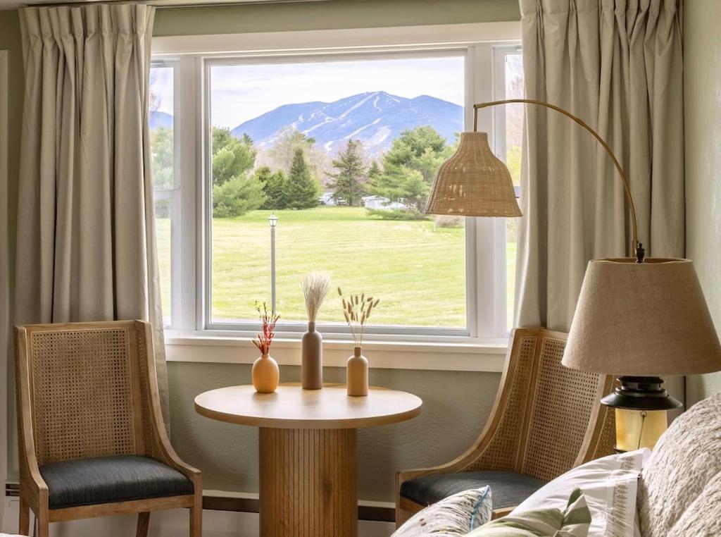 a room with a table and chairs and a window at Gale River House - Boutique Hotel in Franconia