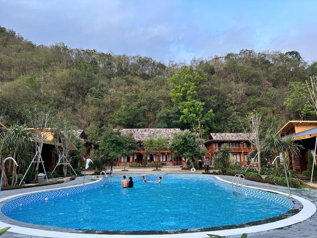 a pool at a resort with people in it at Fullhouse Mộc Châu in Mộc Châu