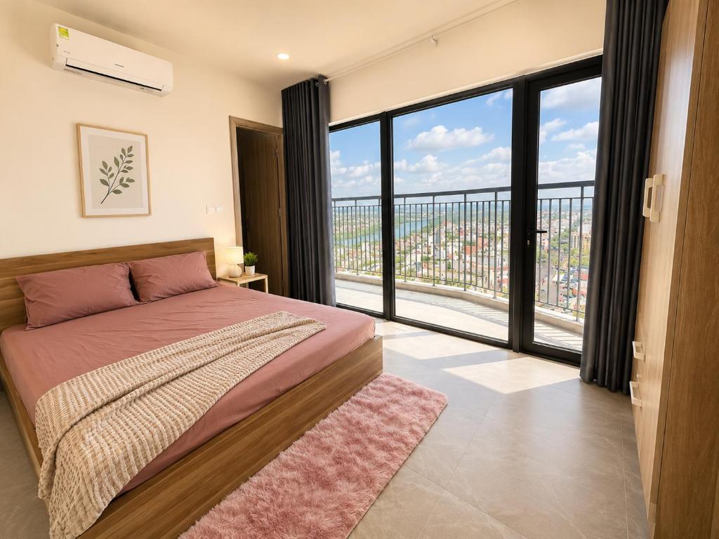a bedroom with a bed and a large window at Jess Apt in Tuy Hoa