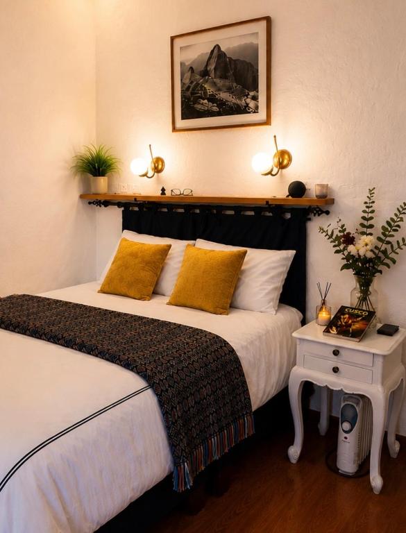 a bedroom with two beds with yellow pillows at Apartamento de confort en el Centro Histórico de Cusco in Cusco