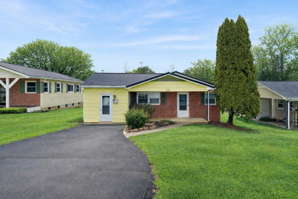 a house with a tree and a driveway at Centralized Modern Home in Johnson City in Johnson City