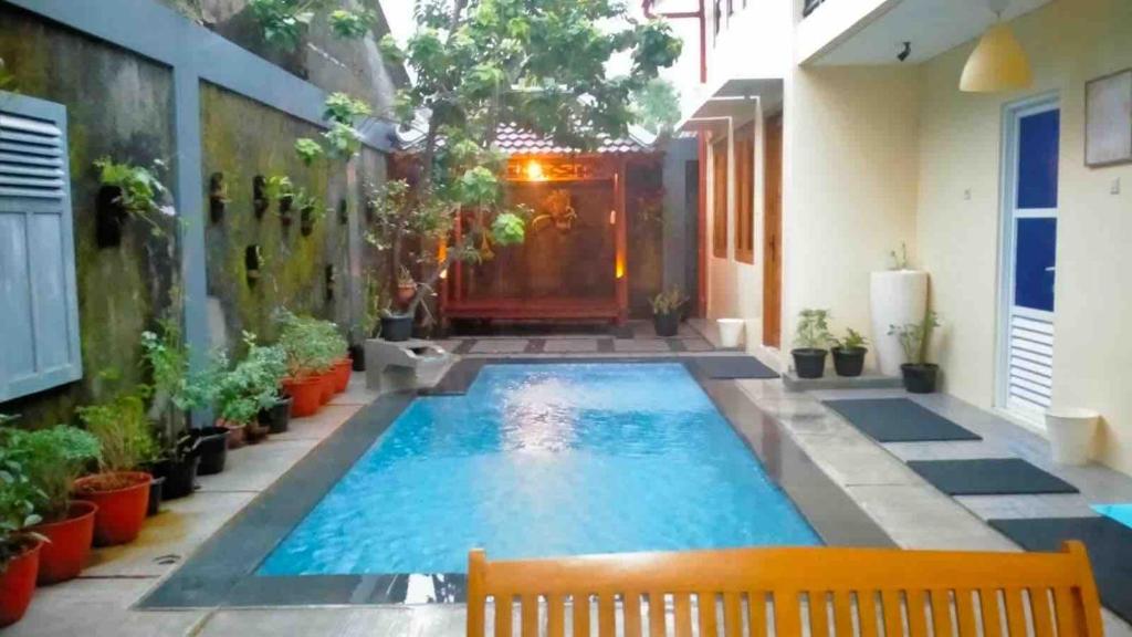 a swimming pool in the middle of a house at Sabi House Sardjono in Yogyakarta