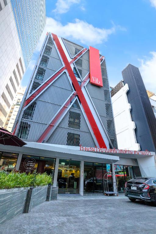 a building with a red cross on the side of it at Vib Best Western Sanam Pao in Bangkok