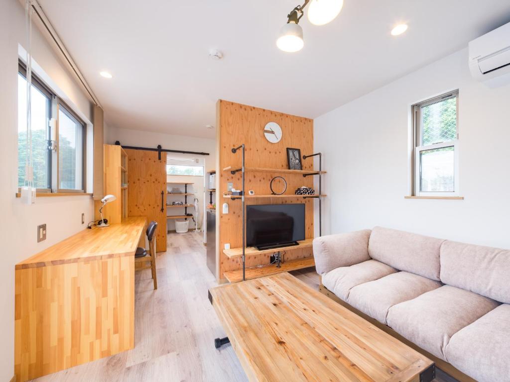 a living room with a couch and a table at Mobile Home 8 in Hokuto