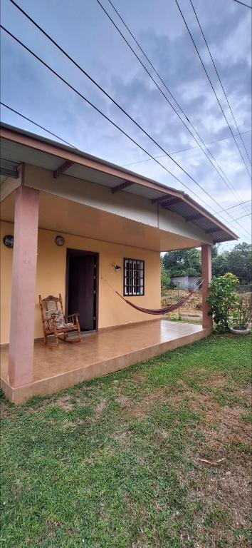 a porch of a house with a chair on it at Casa de Nivia in Acequias Abajo