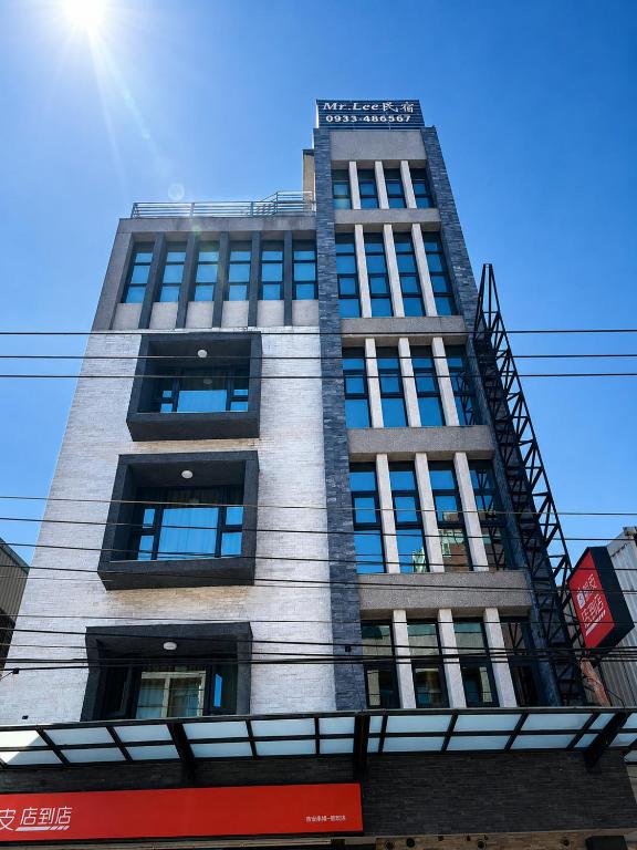 a tall gray building with a fire escape at Mr Lee Elevator B&B Hualien- Near Dongdamen Night Market in Ji'an