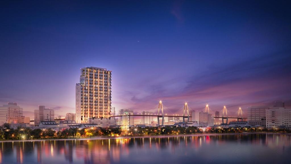 a city skyline at night with a tall building at Manior PentStudio West Lake Accomadi in Hanoi