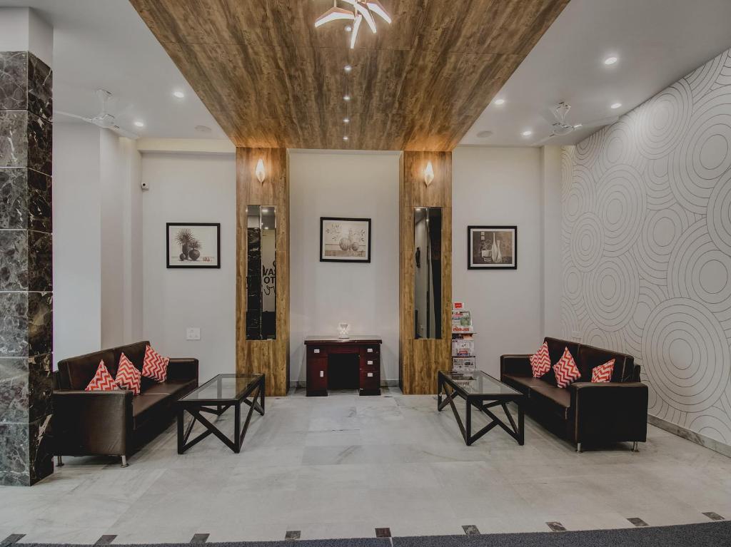 a lobby with two couches and a table at Super Collection O Rajdhani Hotel in Pune