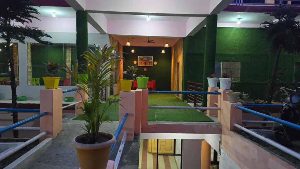 a room with a green wall and a plant at Hotel Shubh Yatra in Nandaprayāg