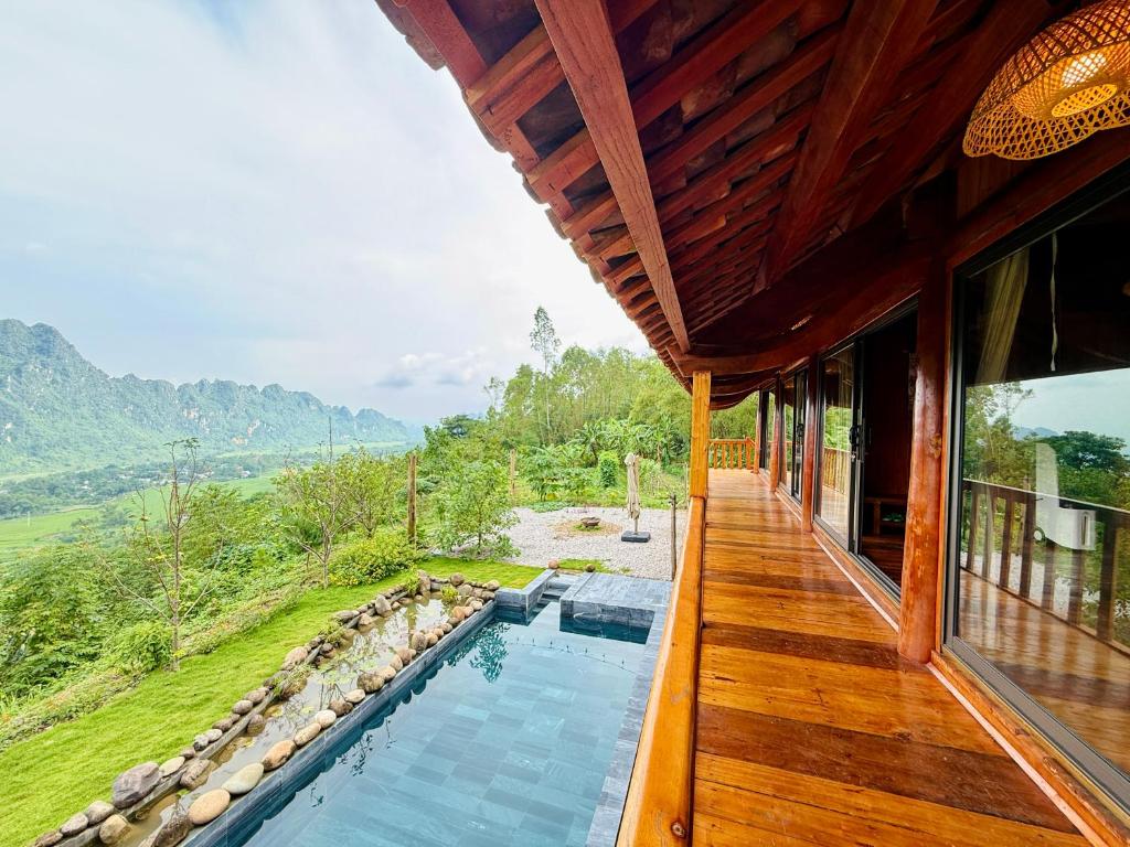 a house with a swimming pool on a deck at MK Home in Lương Sơn