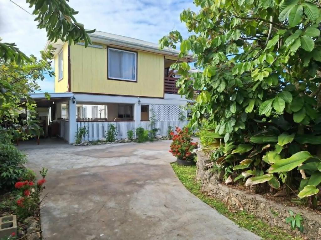 a house with a driveway in front of it at Talipaea Lodge in Nuku‘alofa