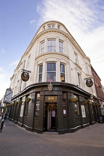a large white building on the corner of a street at The Dickens Bar & Inn in Scarborough