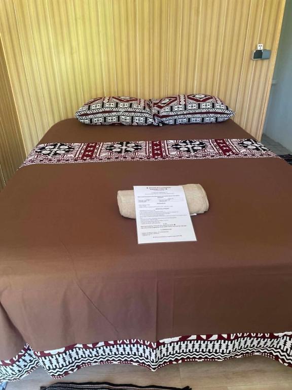a bed with two pillows on top of it at PENSION NATIRENA LODGE Hao in Otepa