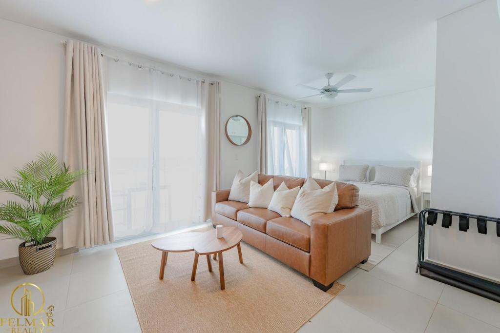 a living room with a couch and a bed at Aura Sosua Ocean Village in Sosúa