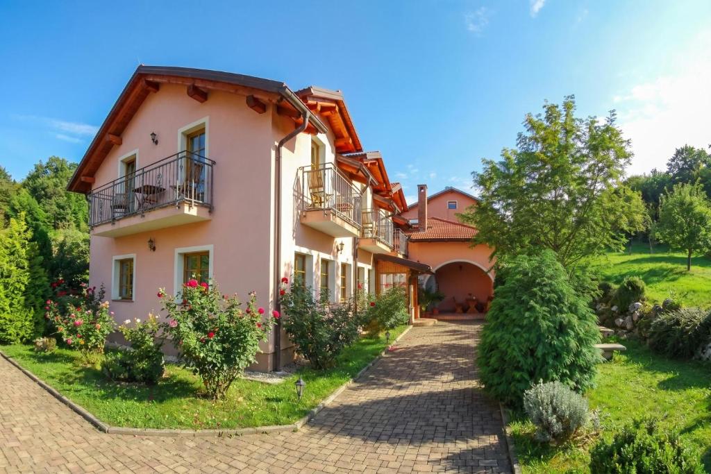 an exterior view of a house with a garden at Pivka Na Meji Resort in Pivka