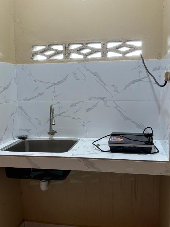 a kitchen counter top with a sink and a sink at Farshada Homestay villa in Kapar