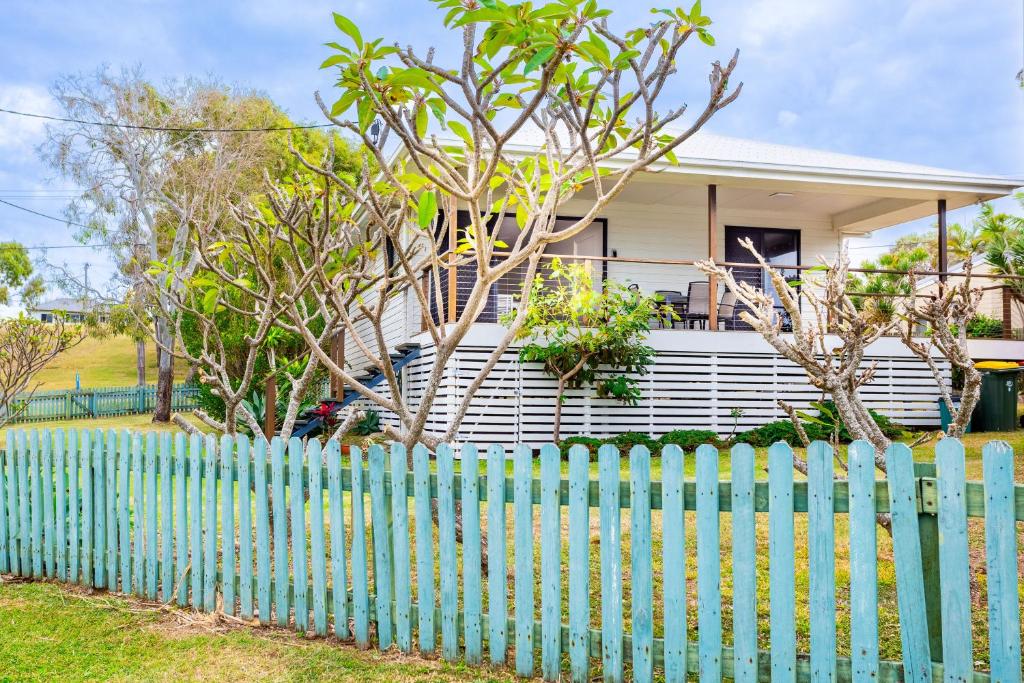 a blue fence in front of a house at 'Flinders' in Yeppoon