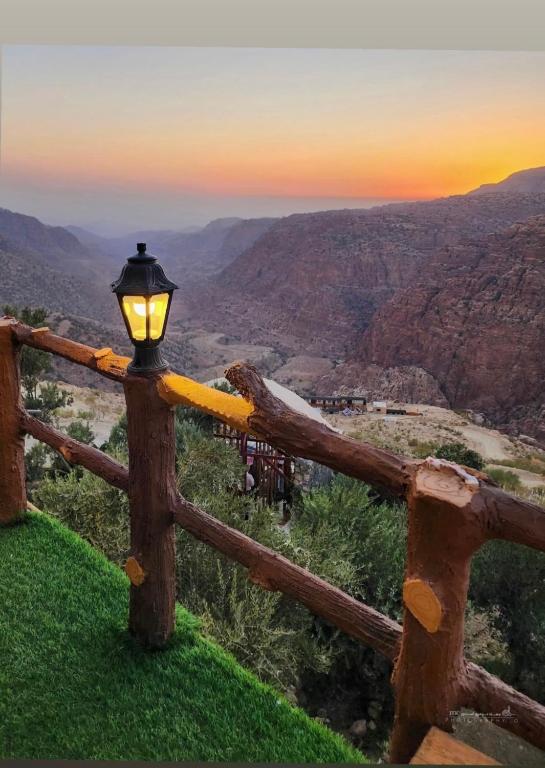 a light on a fence with a view of the canyon at Dana panorama-green camp in Dana