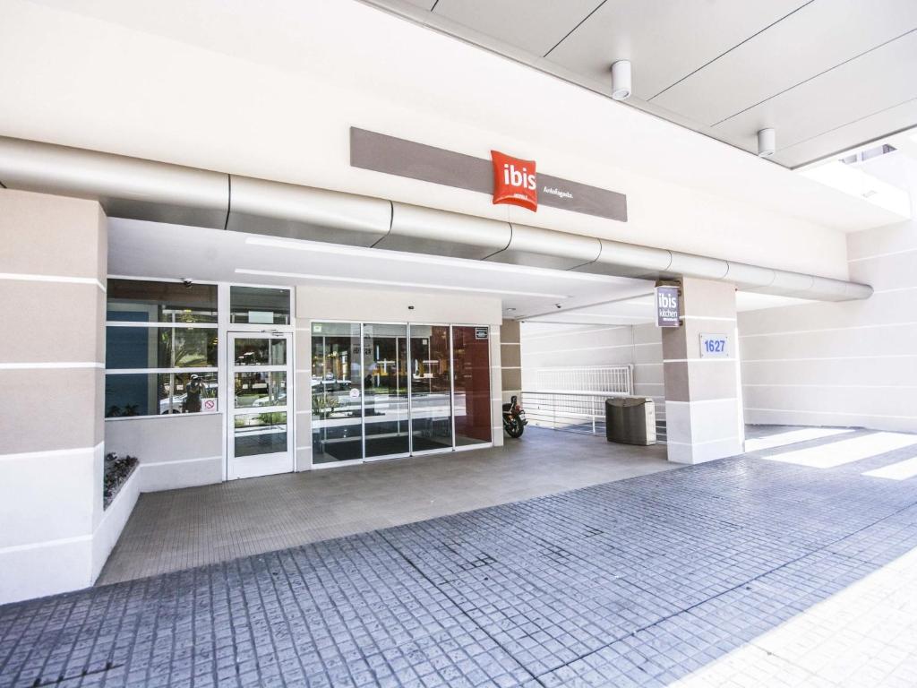 an empty lobby of a building with a hilton sign at ibis Antofagasta in Antofagasta