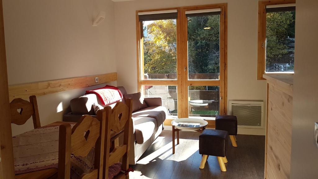 a small room with a bed and a window at Les Brigues in Courchevel