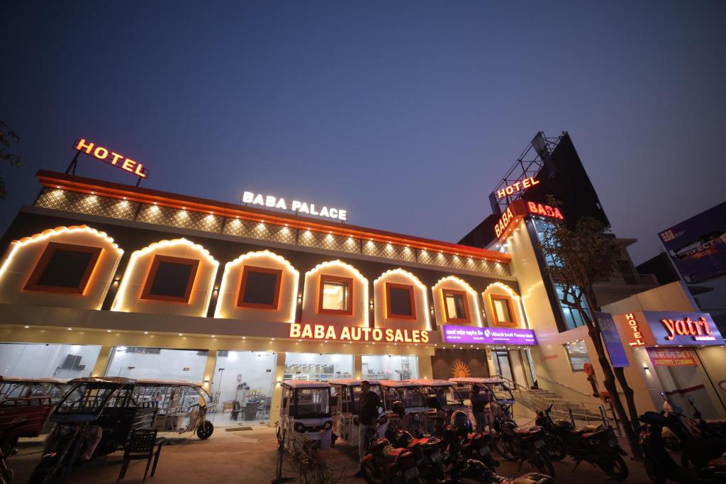 a building with lights and motorcycles in front of it at Baba Palace in Ayodhya