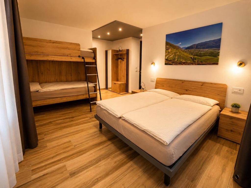 a bedroom with two bunk beds and a ladder at Sweet Alps in Tirano