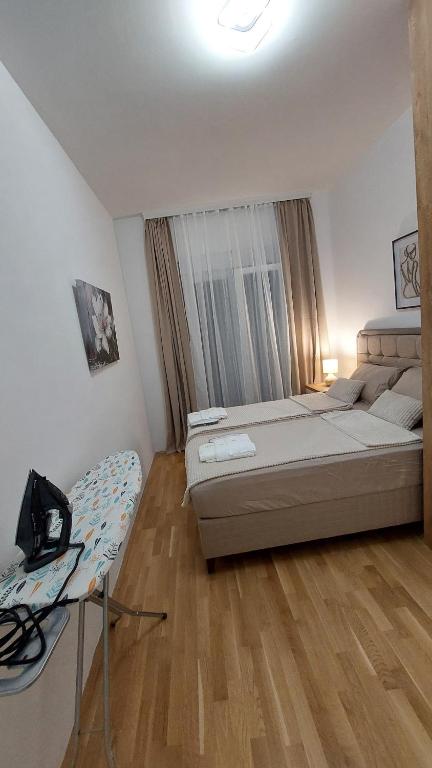 a bedroom with a large bed and a window at D&M Lux1 in Podgorica