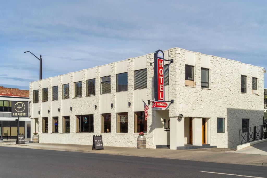 a large white brick building with a sign on it at The Hotel Pendleton, Trademark Collection by Wyndham in Pendleton
