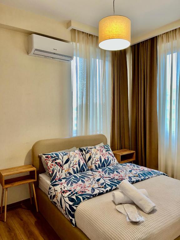 a bedroom with a bed with a towel on it at Central Cozy 2-Bedroom in Tbilisi City
