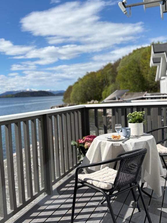 a table and chairs on a balcony with a view of the water at Sea house in beautiful surroundings in Haram