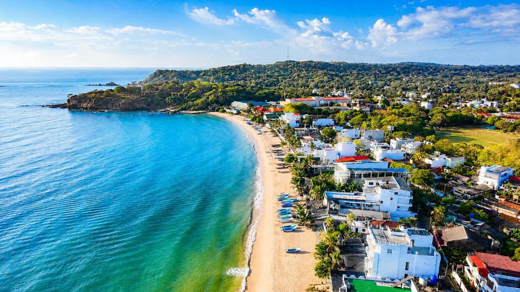 an aerial view of a beach with houses and the ocean at Dutch Bay Villa - Trincomalee in Trincomalee