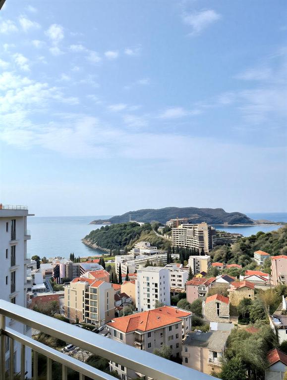 a view from a balcony of a city and the ocean at Azzurro Vista in Budva