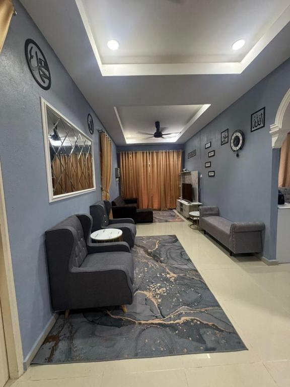 a living room with a couch and a rug at SYA Homestay Bachok in Bachok