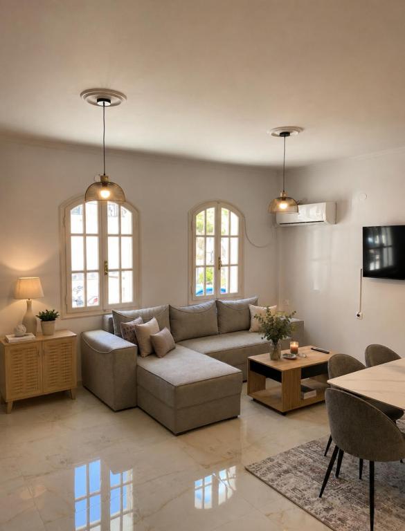a living room with a couch and a table at Villa Harmonia I -Elegant Retreat in Karlovasi