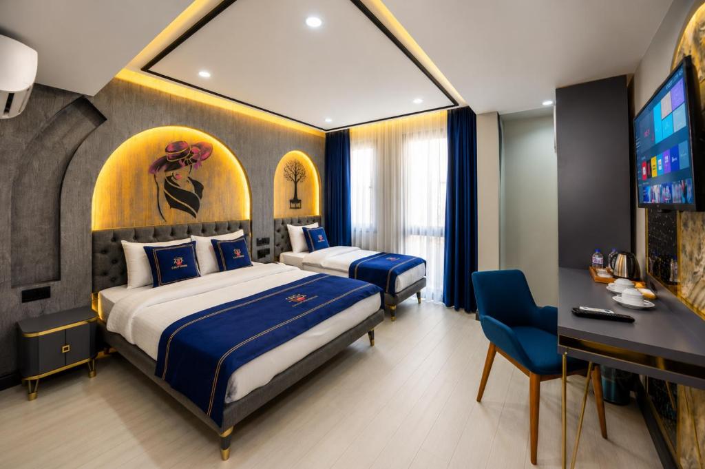 a hotel room with two beds and a flat screen tv at Hotel California in Istanbul