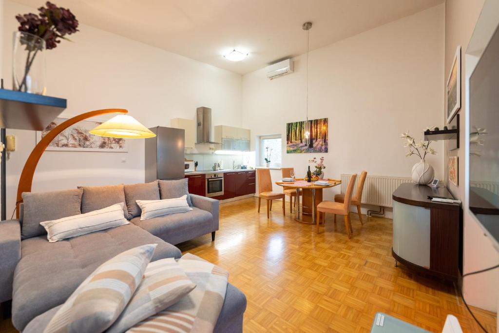 a living room with a couch and a table at Apartma Drapšinova - Celje in Celje