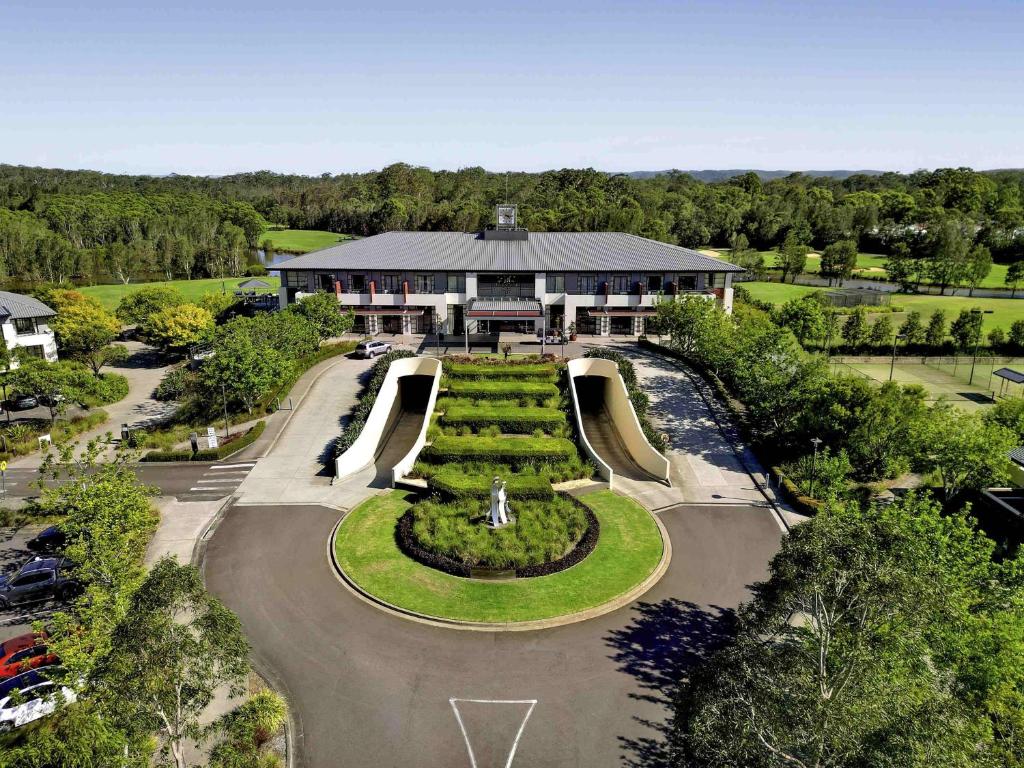 an aerial view of a building with a park at Mercure Kooindah Waters Central Coast in Wyong