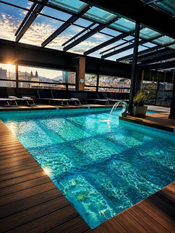 a swimming pool on the roof of a building at Hotel Condestable Iranzo in Jaén