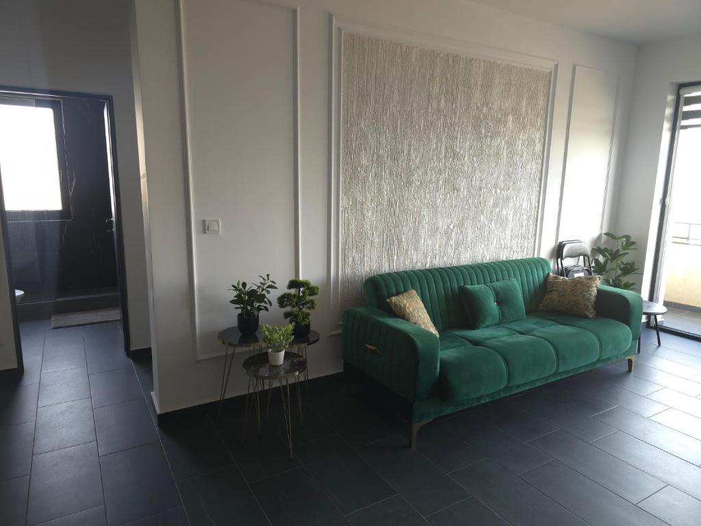 a green couch sitting in a living room at Marcus Residence Apartment in Satu Mare