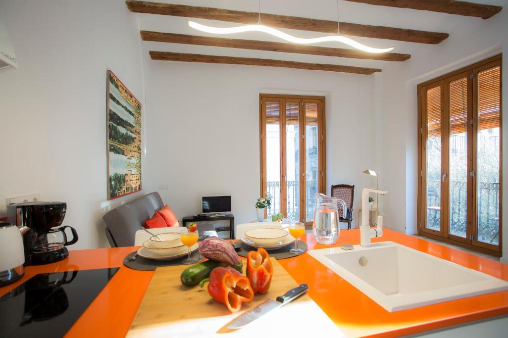 a kitchen with a table with fruits and vegetables on it at Balcón de Manet in Valencia