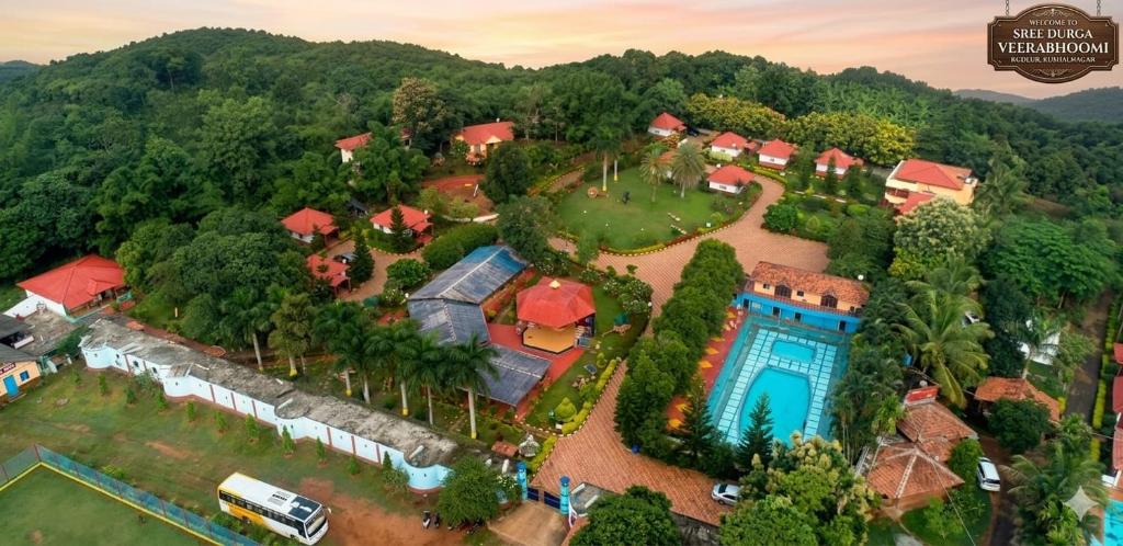 an aerial view of a house with a swimming pool at Sree Durga Veerabhoomi Resort in Kushālnagar
