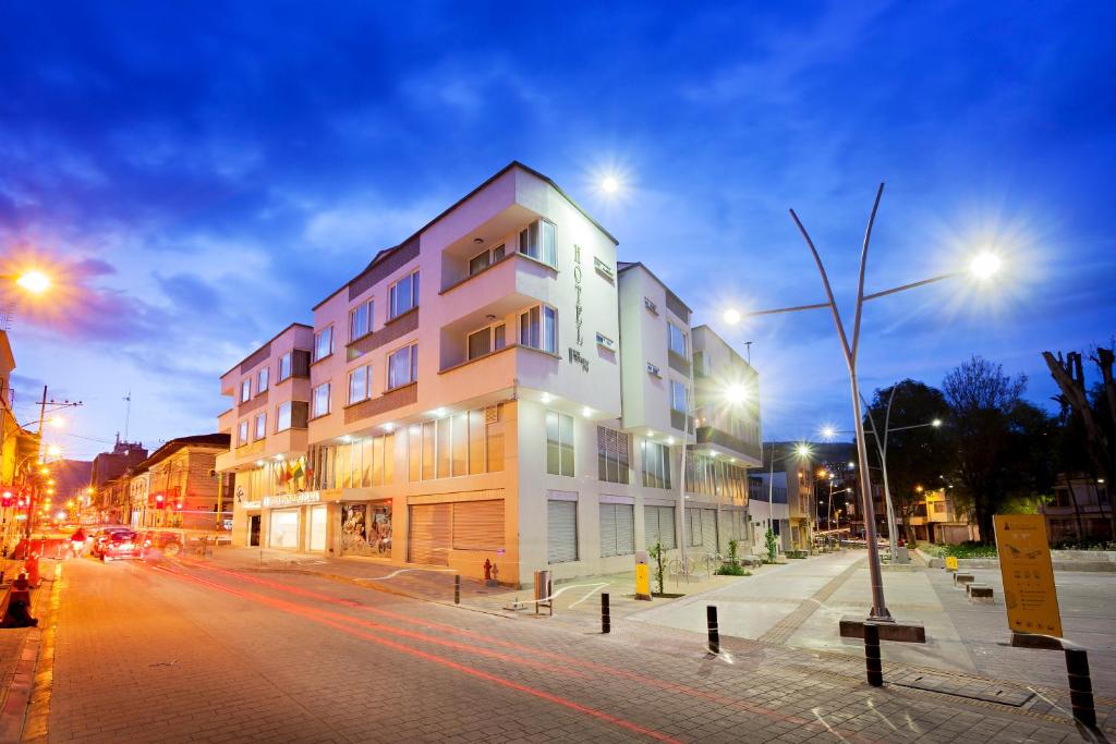 a building on the side of a street at night at Hotel Fernando Plaza in Pasto