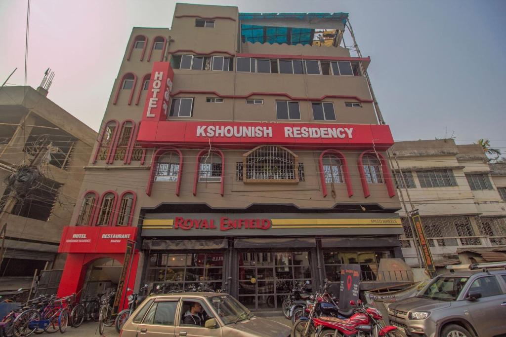 a tall building with akritkritkrit registry in front of it at Hotel O Kshounish Residency in Mālda